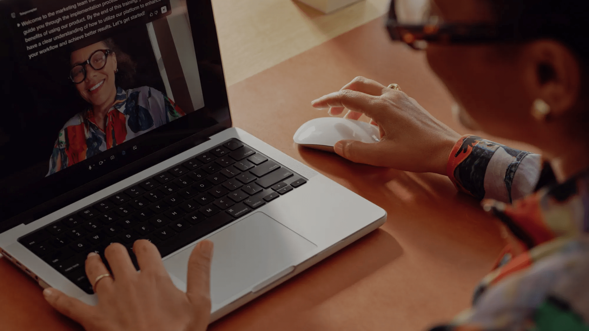 Woman sitting at a laptop doing video training online