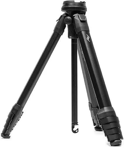 Compact Peak Design Travel Tripod with carbon fiber legs and adjustable ball head, shown in folded position demonstrating its portable design.